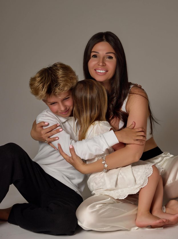 Inessa East hugging her two children