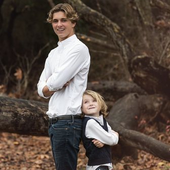 Two brothers posing in an autumn forest