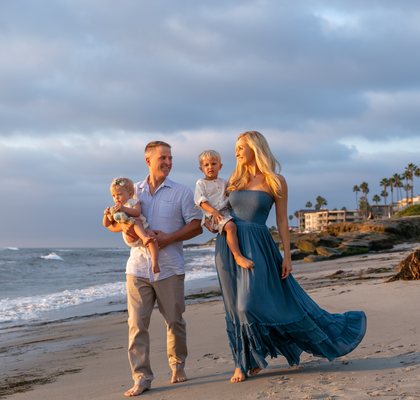 Family walking along the beach in La Jolla at sunset